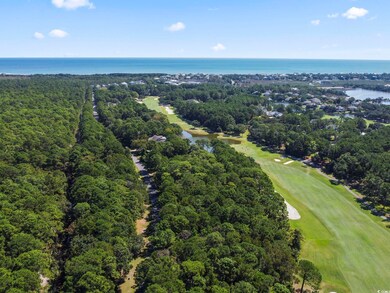 View of property location with a large body of water and a local golf course