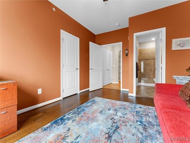 Bedroom featuring connected bathroom, wood finishe