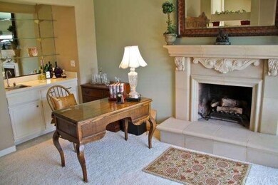 Elegant master suite with a wet bar, balcony, and 