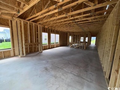 Miscellaneous room with plenty of natural light and concrete floors
