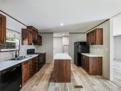Kitchen with a sink, a kitchen island, under cabin