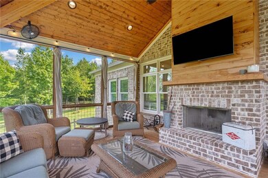 Sunroom featuring lofted ceiling and an outdoor living space with a fireplace