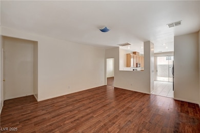 Unfurnished living room featuring dark wood finish