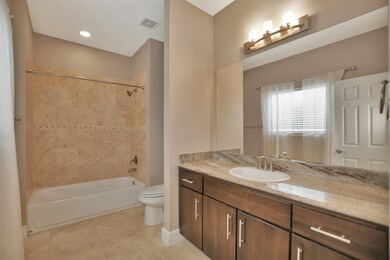 The spacious secondary bathroom is separate from t
