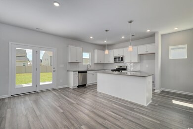 Kitchen with visible vents, decorative backsplash,