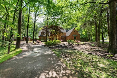View of front of home featuring aphalt driveway