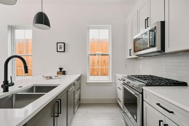 Kitchen with a sink, light wood-type flooring, li