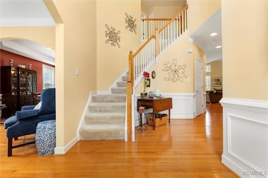 Stairway with arched walkways, wood finished floor