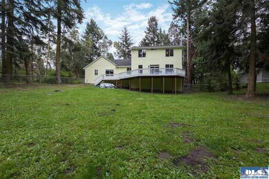 Through door under deck.  Firewood in foreground conveys.