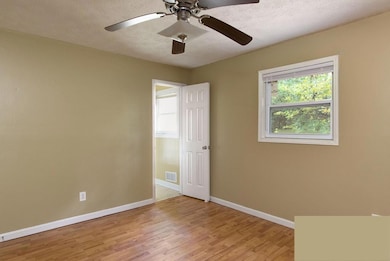 Unfurnished room featuring light wood-type flooring, ceiling fan, and a textured ceiling