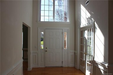 Soaring 2 story foyer with hardwoods and large pal
