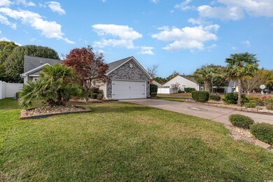 View of front of house featuring a front yard and a garage