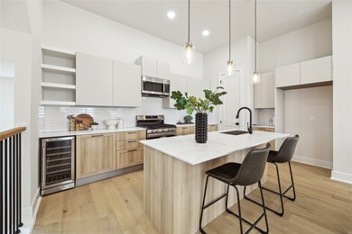 Modern kitchen featuring sleek cabinetry, a spacio