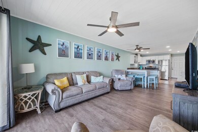 Living room with a ceiling fan, wood finished floors, ornamental molding, and recessed lighting
