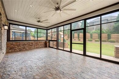 Unfurnished sunroom featuring ceiling fan