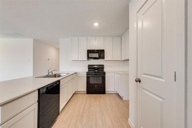 Kitchen with sink, light hardwood / wood-style flo