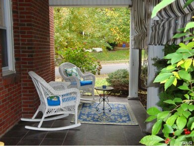 Side Porch With Slate Flooring And Awnings