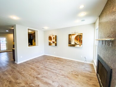 Unfurnished living room featuring wood finished f