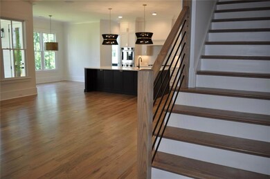 View from foyer into the open floorplan featuring vaulted great room, kitchen, scullery, and breakfast area. Representative photo of the Rebecca interior, may include additional options