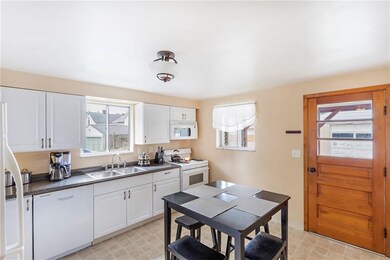 Kitchen with lots of natural light.  Door leads to