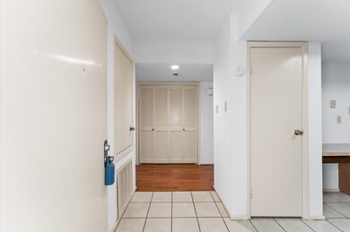 The photo features a hallway with white walls and