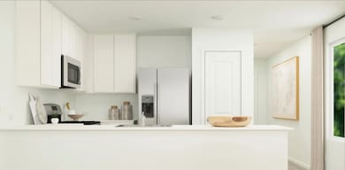 Open floor plan where kitchen looks upon dining an