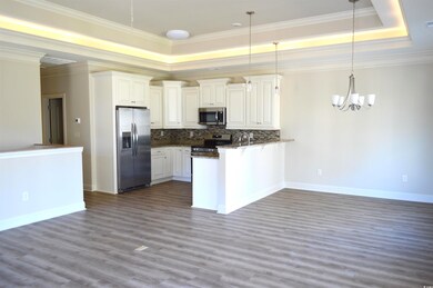 Kitchen featuring kitchen peninsula, appliances wi