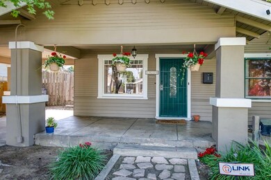 Covered porch with steps and a stone walkway