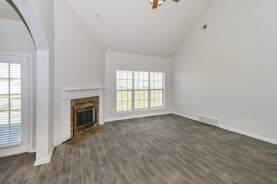Unfurnished living room featuring a fireplace, a w