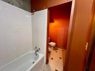 Full bath with shower / bathtub combination and ti