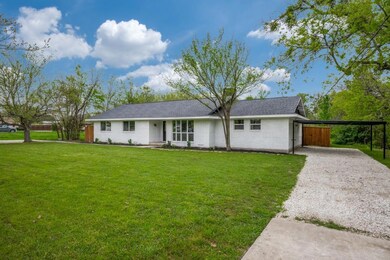 Ranch-style home with a front lawn, gravel drivewa