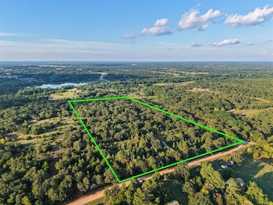 Aerial overview of property's location with a large body of water and property boundaries highlighted