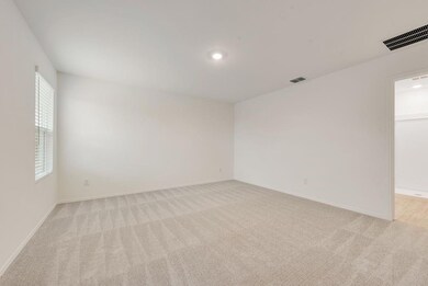 Spare room with baseboards, visible vents, and lig