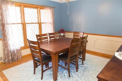 The formal dining area has large open windows, har