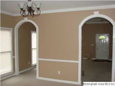Dining room with attractive arched entry to kitche