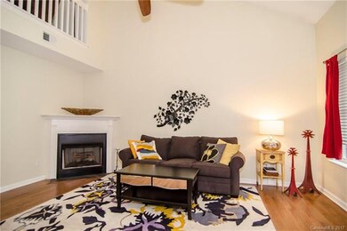 Open living area with an electric fireplace. Flip 