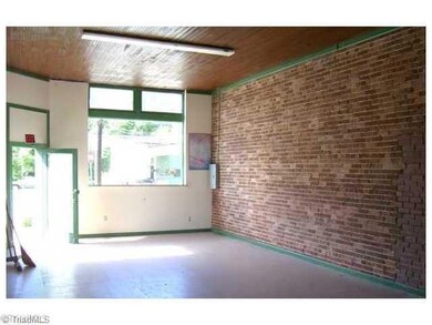 Entry. Unit 1. Front entrance. Tiled floor. Wood ceiling. Brick wall. Open.
