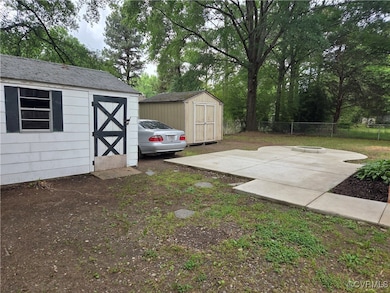 View of yard featuring a storage shed and a patio
