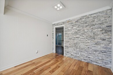 Empty room featuring wood finished floors, baseboa