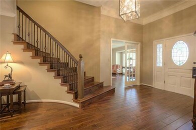 Dramatic roomy entry with beautiful wood floors, b