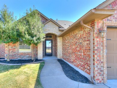 View of exterior entry featuring mulched flower be