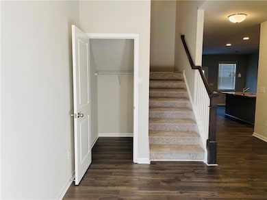 Staircase featuring wood finished floors and recessed lighting