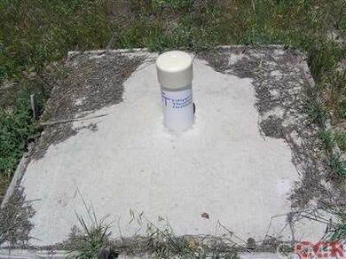 Cased and capped well near Gillett Rd on eastern e