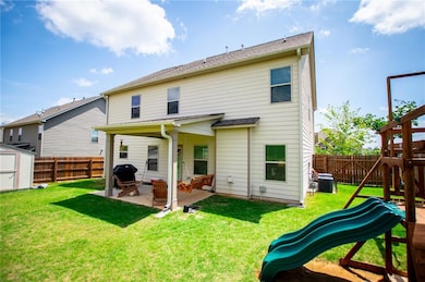 Back of house with a playground, a patio area, and central AC unit