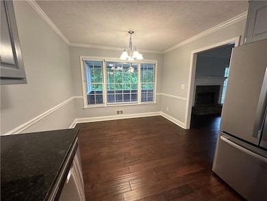 Unfurnished dining area featuring a textured ceili
