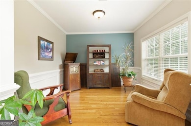Formal living room with natural light and hardwood floors