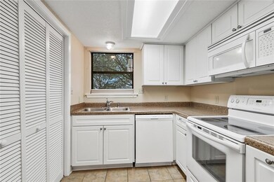 Kitchen.  Laundry area behind the folding doors on
