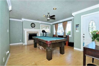 Warm, welcoming fireplace & ceiling fan make this 