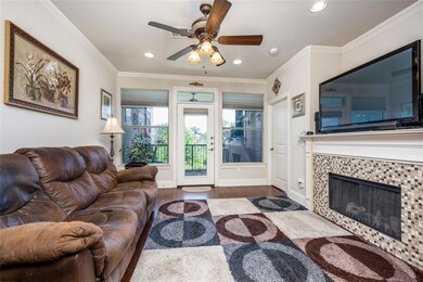 Living room featuring tile Surround fireplace. Ins