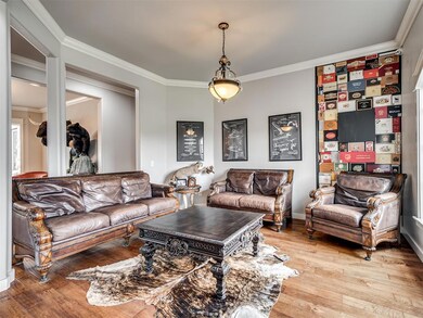 Living room with ornamental molding and hardwood /